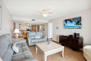 a living room with a couch and a table at Las Brisas 202 in St Pete Beach