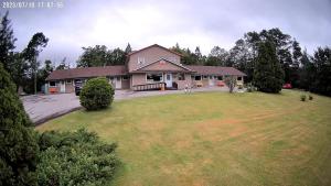 a house with a large yard in front of it at Sherbrooke Village Inn in Sherbrooke