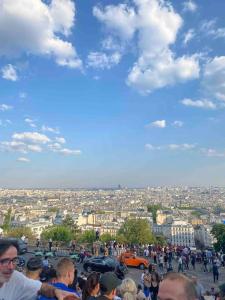 a crowd of people standing around a city at T2 Sacré Cœur - Butte Montmartre - Abbesses in Paris