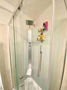 a shower in a bathroom with a glass shower stall at T2 Sacré Cœur - Butte Montmartre - Abbesses in Paris