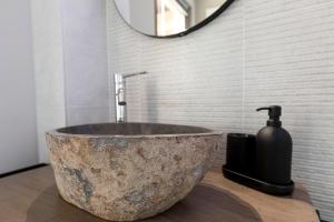 a bathroom with a large stone sink and a mirror at Casa Belvedere Egro - tiny house in Cesara