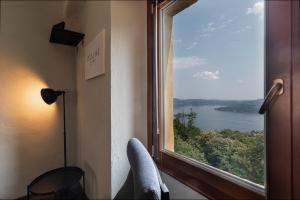 a room with a window with a view of a lake at Casa Belvedere Egro - tiny house in Cesara