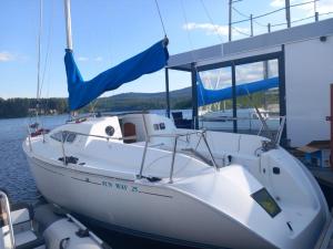a white boat is docked in the water at Jeanneau Sun Way 25 in Hrdoňov