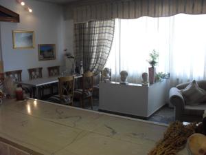 a living room filled with furniture and a large window at La Santre Villa in Amoudara Herakliou