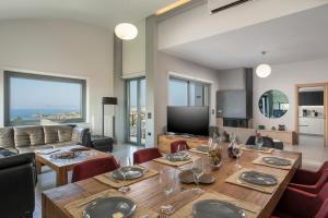 a living room with a table and a couch at Elysium Seaview Oasis in Kato Galatas