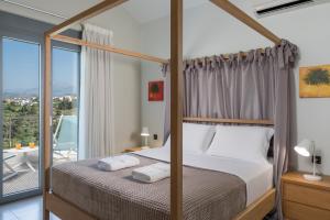 a bedroom with a bed and a balcony at Elysium Seaview Oasis in Kato Galatas