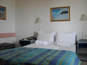 a bedroom with a bed and two night stands and two lamps at La Santre Villa in Amoudara Herakliou