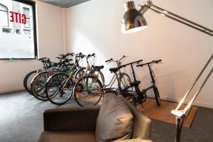 una habitación con un montón de bicicletas aparcadas contra una pared en Gîte de Tournai - les beaux-arts, en Tournai