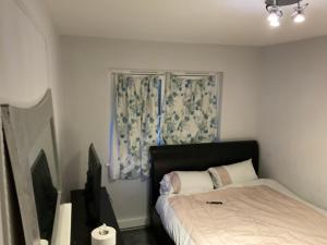a small bedroom with a bed and a window at Road to home in Abbey Wood