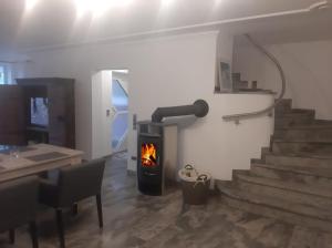 a living room with a fireplace and a stove at Ferienhaus Marktredwitz in Marktredwitz