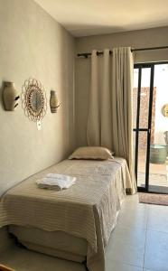 Postel nebo postele na pokoji v ubytování FLAT 104 Luis Correia Vila Atlântida + 8 fotografií