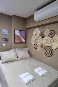 1 dormitorio con 1 cama con toallas en FLAT 104 Luis Correia Vila Atlântida en Luis Correia