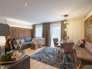 a living room with a couch and a table at Landhaus Dengg in Gerlos