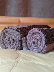 a bed with two pillows and a blanket at SWEEPH in Mestia +73 photos