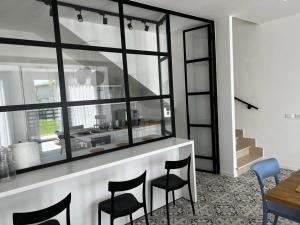 a kitchen with a counter with chairs and a table at Elios Badino B&B in Terracina