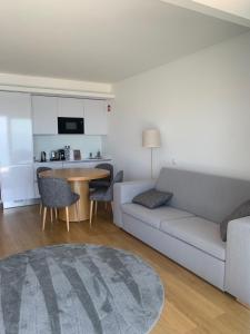 a living room with a couch and a table at SESIMBRA SOL in Sesimbra