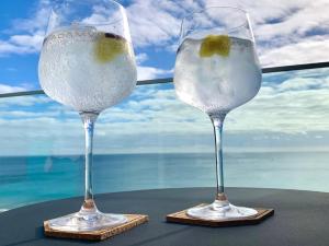 two glasses of wine sitting on top of a table at SESIMBRA SOL in Sesimbra