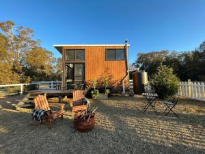 a tiny house sitting on top of a yard at Yellow Rock Views in Broke