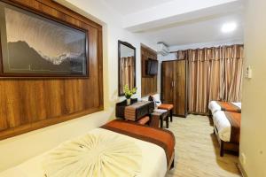 מיטה או מיטות בחדר ב-Hotel Himalayan Oasis