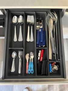 a drawer filled with utensils and utensils at Isabel's House in Arco