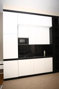 a kitchen with white cabinets and a microwave at Sea Breeze in Baku