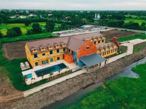 an overhead view of a large house on a river at Tuscany Hotel Buriram in Buriram