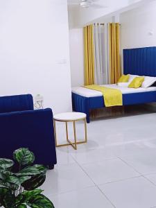 a bedroom with a bed and a couch and a table at Medzam Homes Spacious Newly Furnished Studio in Mombasa