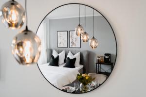 a bedroom with a bed and a mirror at Wohntraum für 3 mit Blick auf den Wismarer Hafen in Wismar
