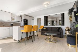 a kitchen and living room with a couch and chairs at Golden Paradise Port nature village in Cap d'Agde