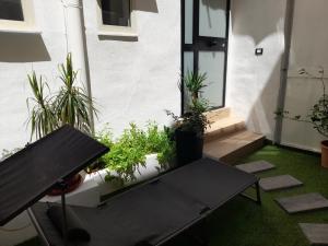 a patio with a table and potted plants at Garden Suite Apartment in Palermo