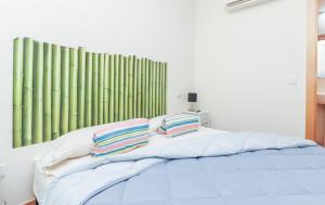 ein Bett mit zwei Kissen darüber in der Unterkunft Bright duplex apartment for families-VICALV in Madrid