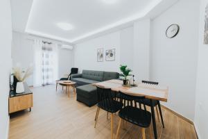 a living room with a couch and a table at Comfy and Stylish apartment Thessaloniki in Thessaloniki