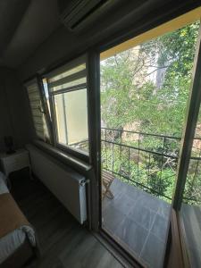 a room with two large windows and a balcony at 1453Apartments in Istanbul
