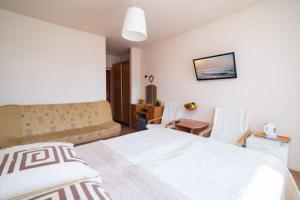 Postel nebo postele na pokoji v ubytování Dom Wczasowy Klif & Spa