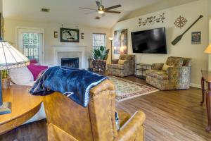 a living room with a couch and a tv at Pet-Friendly Savannah Rental with Community Pool! in Savannah