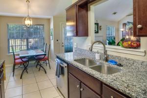 a kitchen with a sink and a table with chairs at Pet-Friendly Savannah Rental with Community Pool! in Savannah