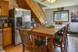 a kitchen with a wooden table and a refrigerator at Upstate New York Home Near Snowmobiling and ATVing! 