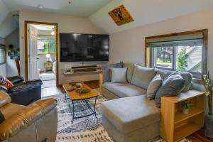 a living room with a couch and a tv at Upstate New York Home Near Snowmobiling and ATVing! 
