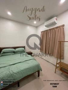 a bedroom with a bed and a sign on the wall at Villa The Quarry in Segamat