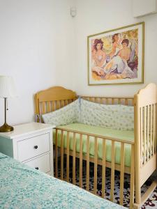 a nursery with two cribs and a painting on the wall at Residenza Gli Oleandri in Formia