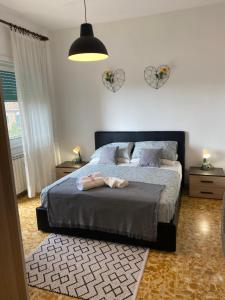 a bedroom with a bed with two shoes on it at Pisana 247 St Peter in Rome
