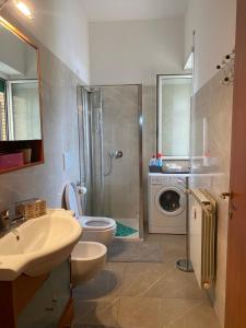 a bathroom with a toilet and a sink and a washing machine at Pisana 247 St Peter in Rome +14 photos