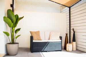 a porch with a couch and a plant at VILLA AMBROSIA 172 A in Terracina