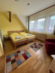 a bedroom with a bed and a rug at Privatzimmer Familie Pair/Schmoll in Spital am Semmering