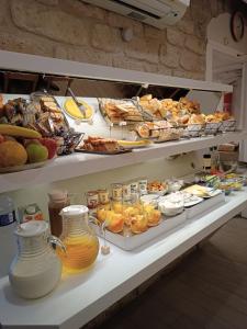 a buffet with many different types of food on display at Hotel Aida Marais in Paris