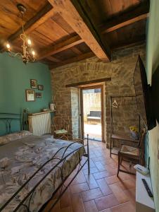 a bedroom with a bed and a stone wall at B&B il Tartufo in Sozzi