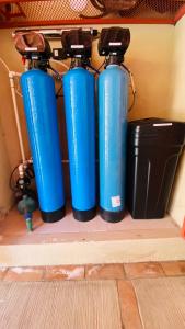 three blue fire hydrants sitting on a shelf at San Angel Villas in San Antonio