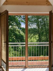 an open window with a view of a balcony at Moorblick! Große Dachwohnung mit Kamin und Sauna in Leck