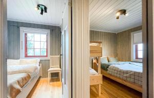 a bedroom with two beds and a bunk bed at Awesome Home In Reinli With Sauna And 4 Bedrooms in Reinli