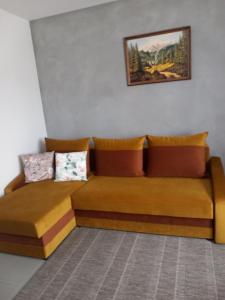 a couch in a room with a painting on the wall at Domek Pod Prehybą -Agroturystyka in Gaboń +26 photos